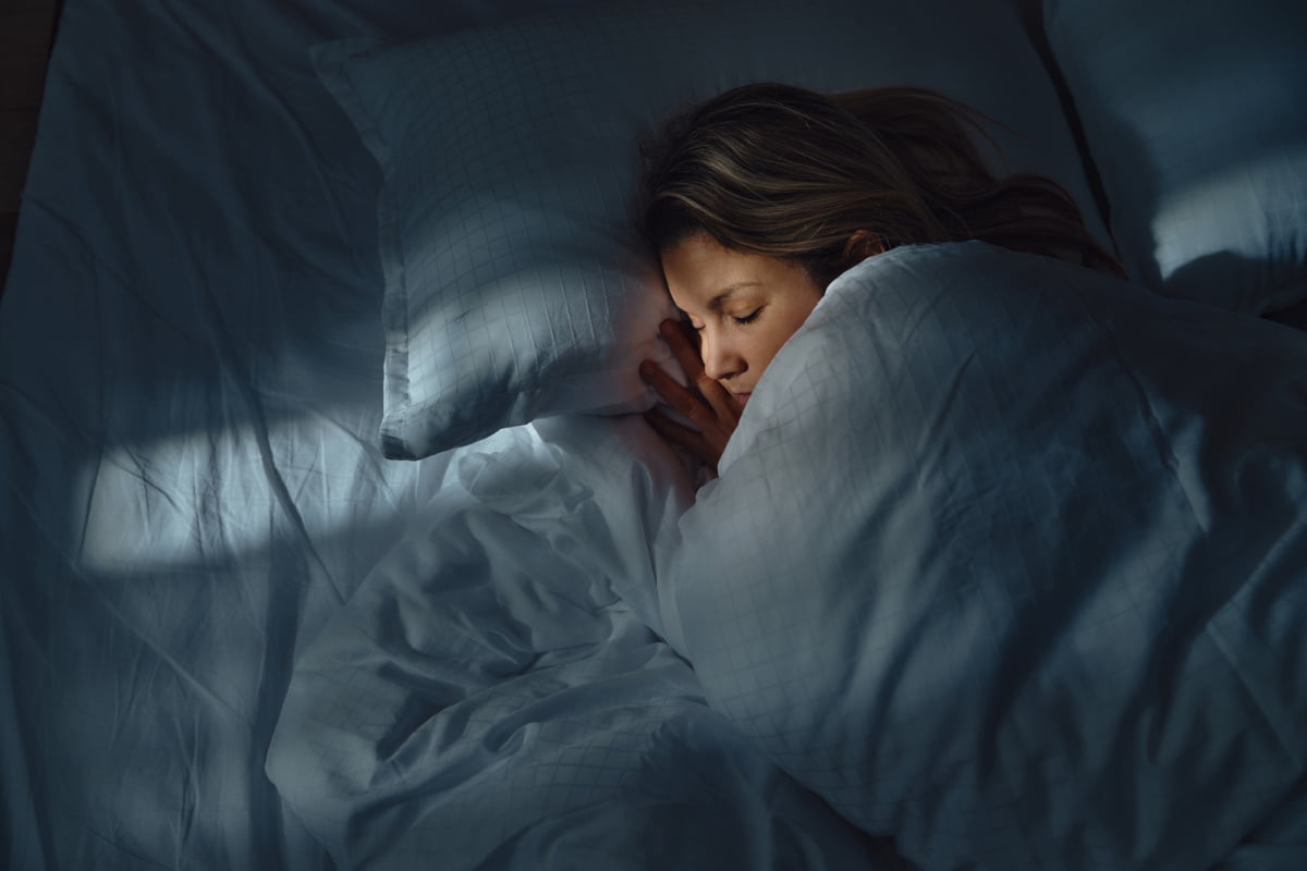 Woman sleeping in bed at night