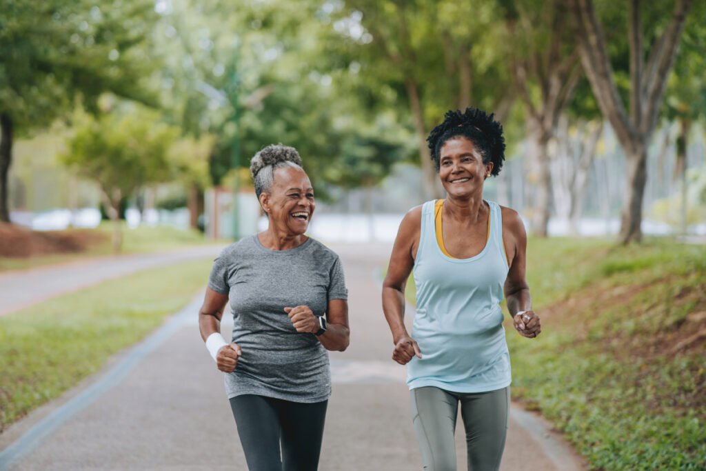 Two mature women powerwalking outside together 