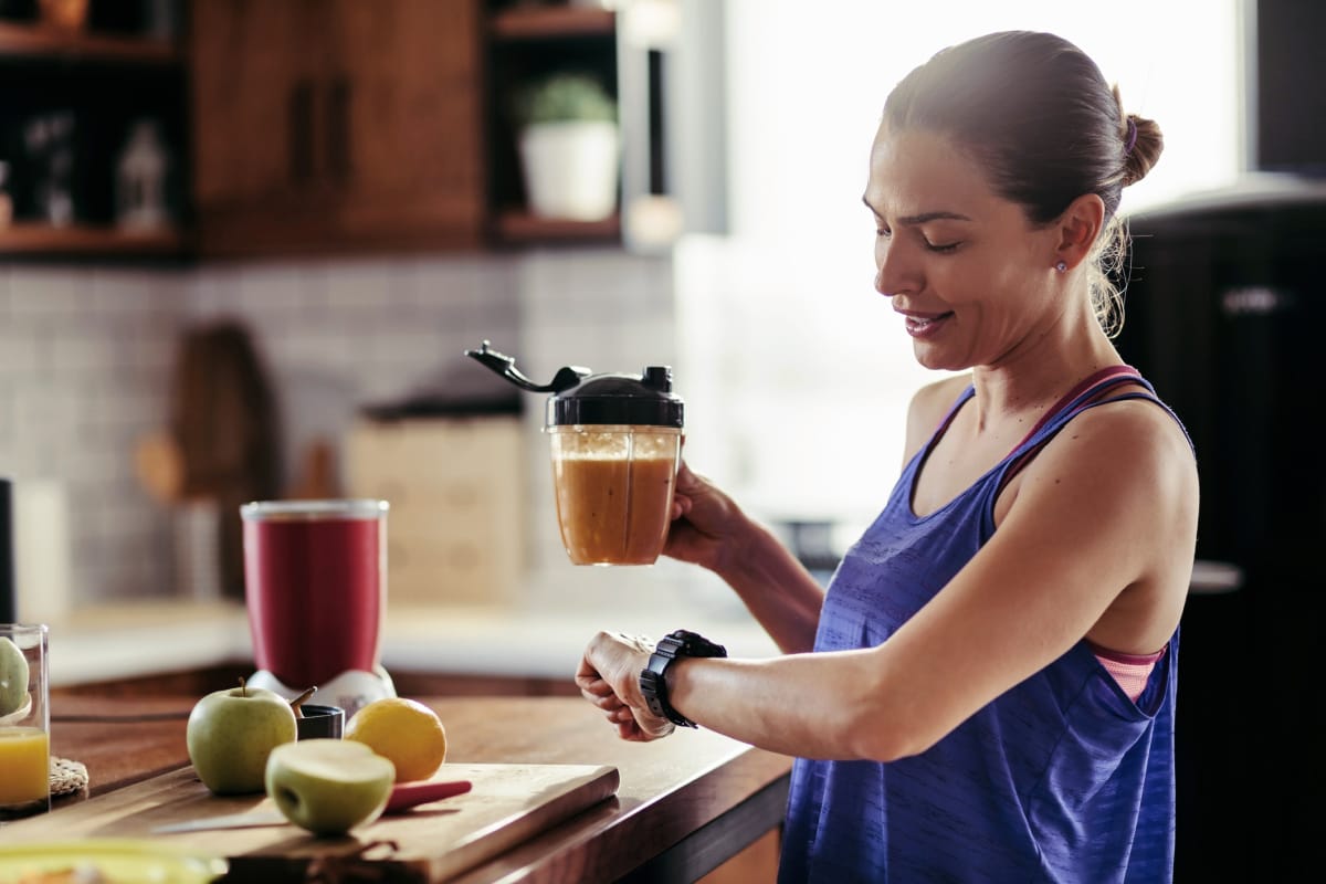 Woman checking watch at the end of her intermittent fasting window