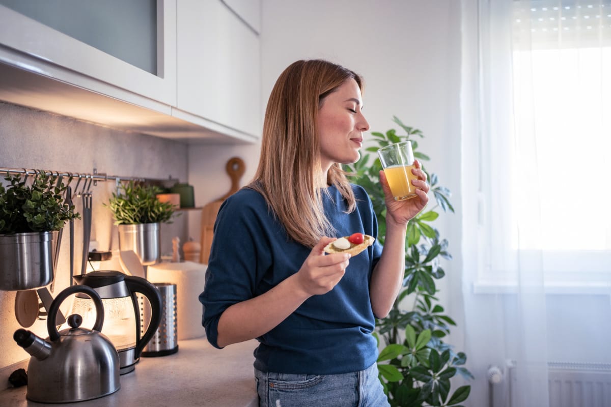 Woman starting day with healthy breakfast and drink